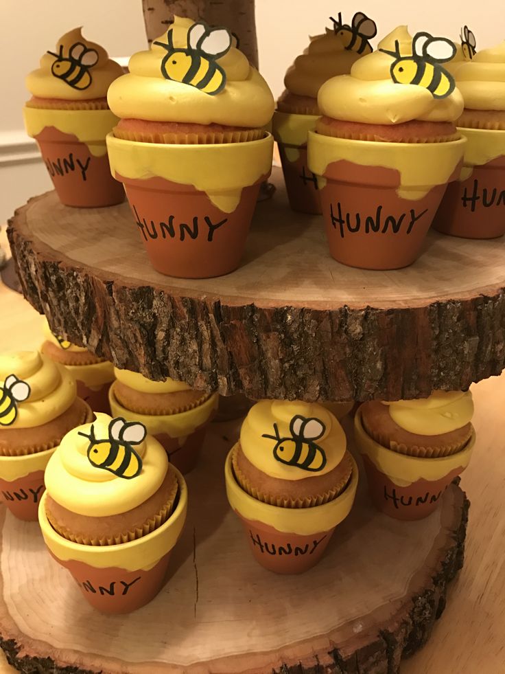 Bee cupcakes on wooden centerpiece for baby shower dessert tables - great idea for Winnie the Pooh baby shower or Mommy to Bee baby showers