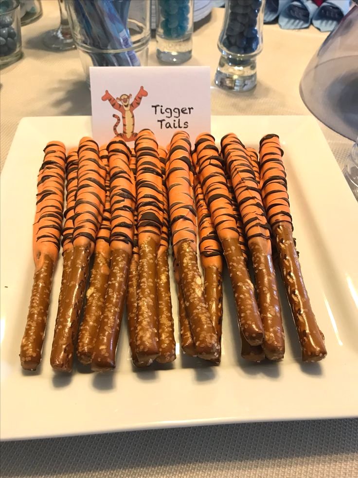 Tigger Tails - chocolate covered pretzels with orange candy melts and drizzled chocolate - perfect idea for Winnie the Pooh baby shower desserts or shower favors