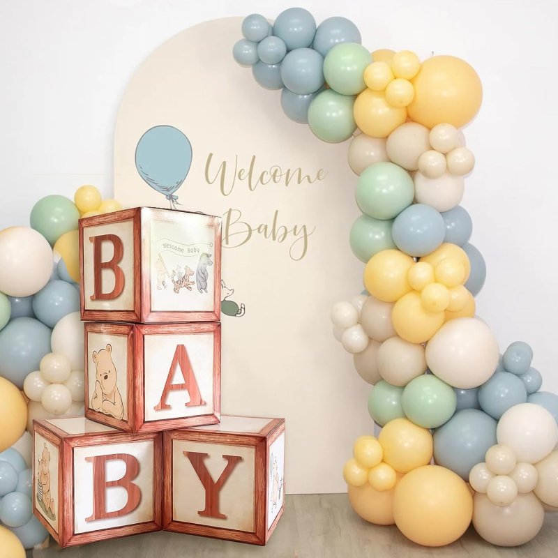 welcome baby backdrop, balloon arch, baby blocks for a winnie the pooh baby shower