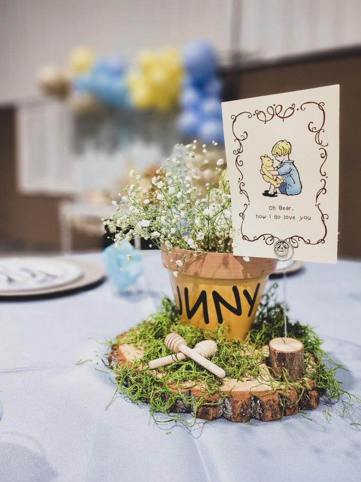 Beautiful Winnie the Pooh baby shower centerpiece featuring Hunny pots and Winnie the Pooh characters